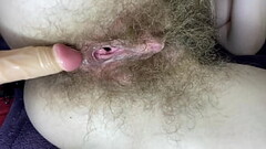 Hairy girl fucks her wet big clit pussy with dildo in close up Thumb